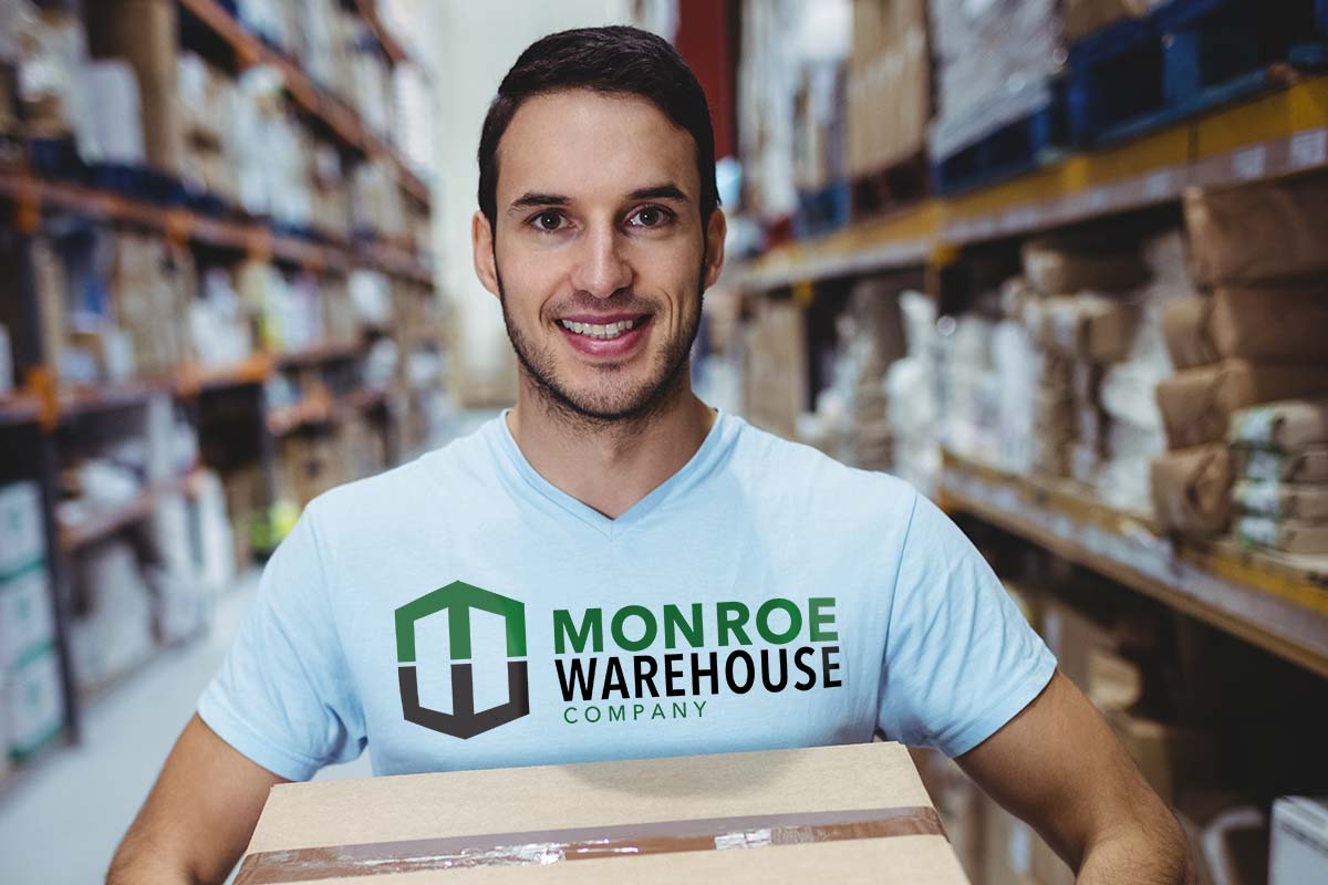 photo of man carrying a box in a t-shirt with a logo