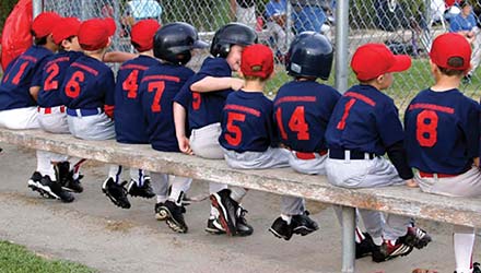 photo of boys on a baseball bench
