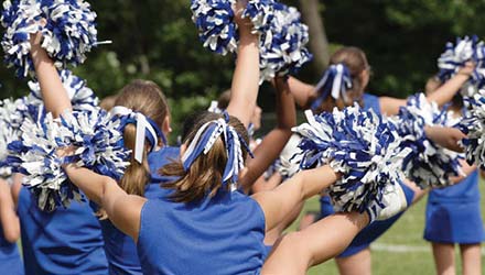 photo of cheerleaders cheering facing away