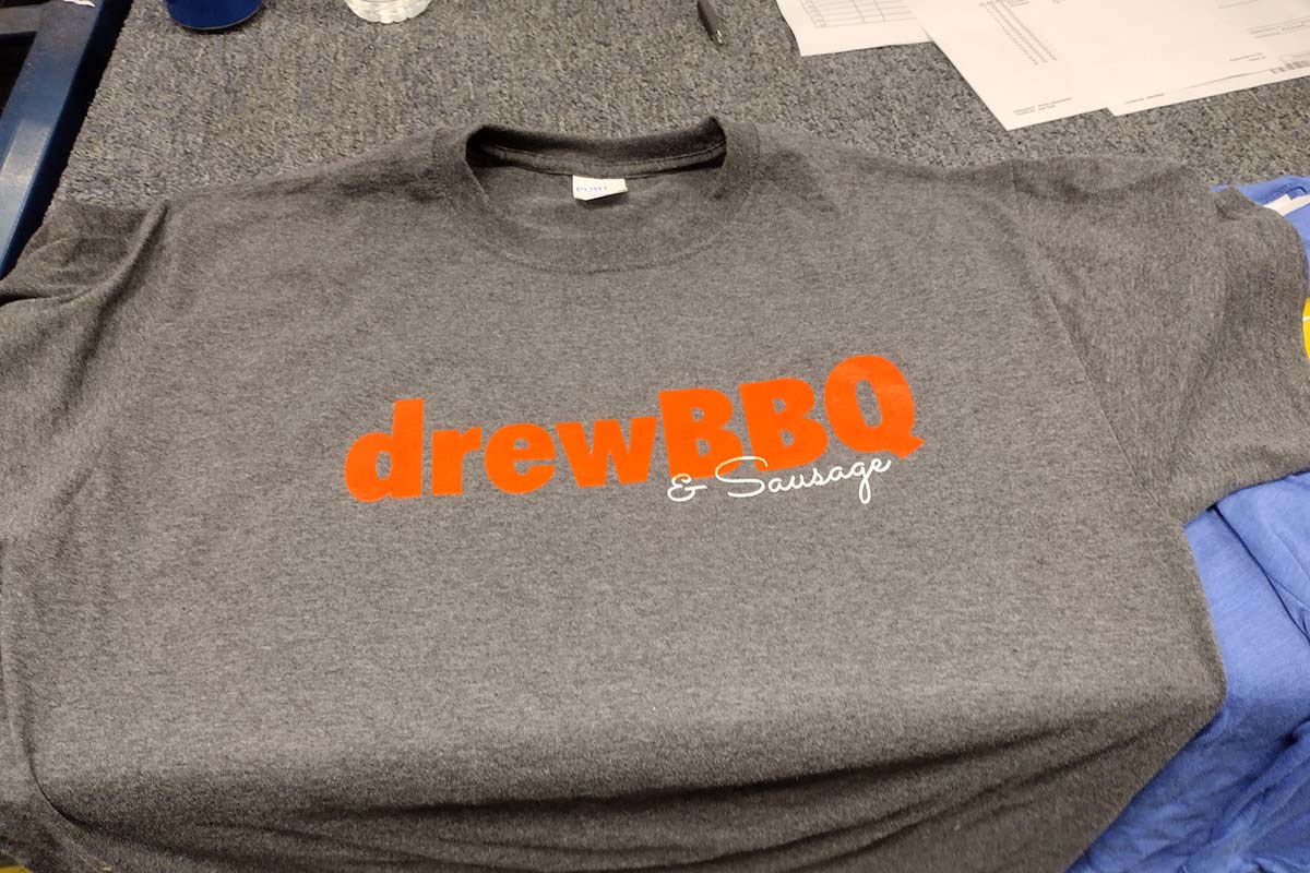 grey shirt with "drewBBQ" logo